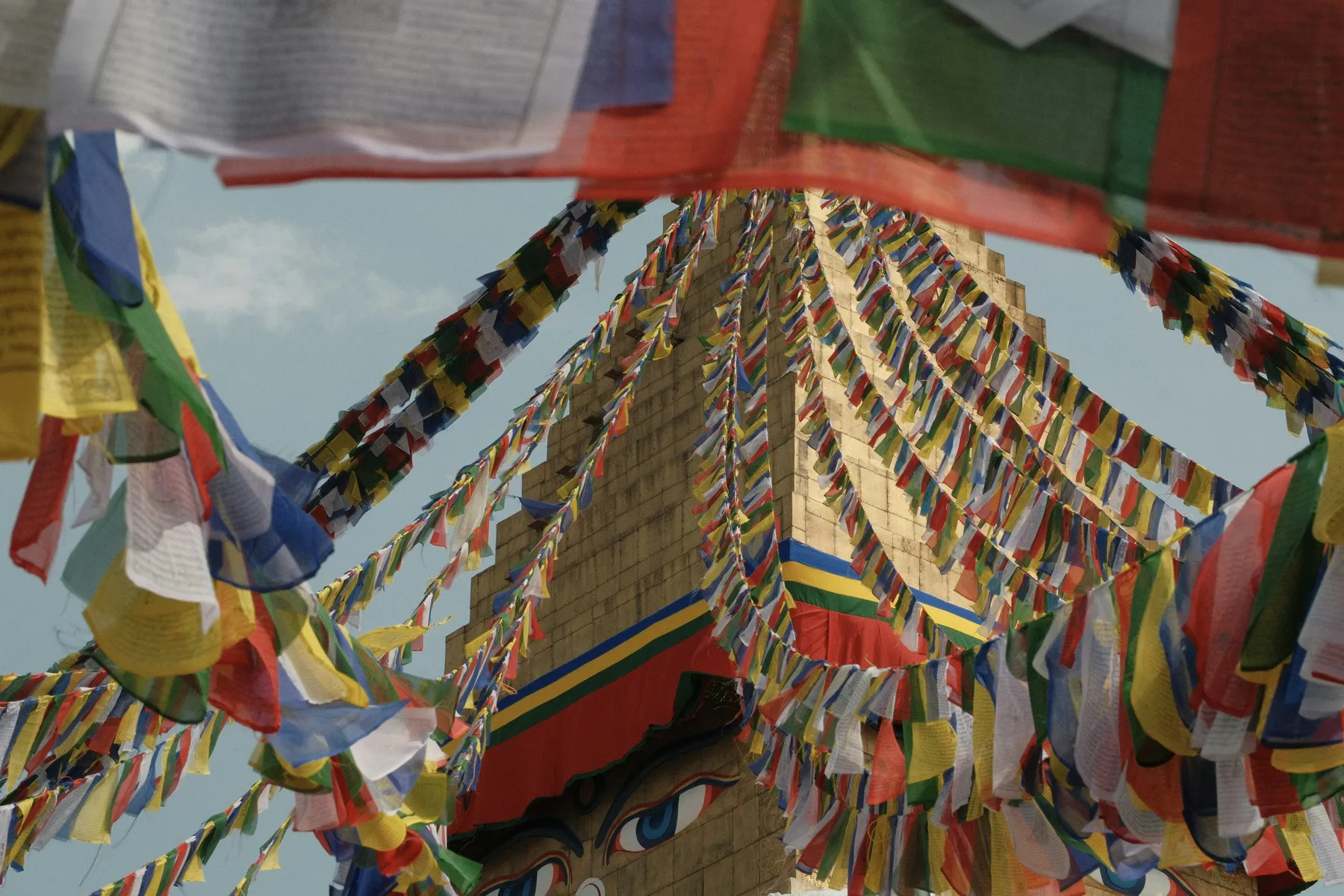 Colourful prayer flags radiating across a white stupa in Kathmandu
