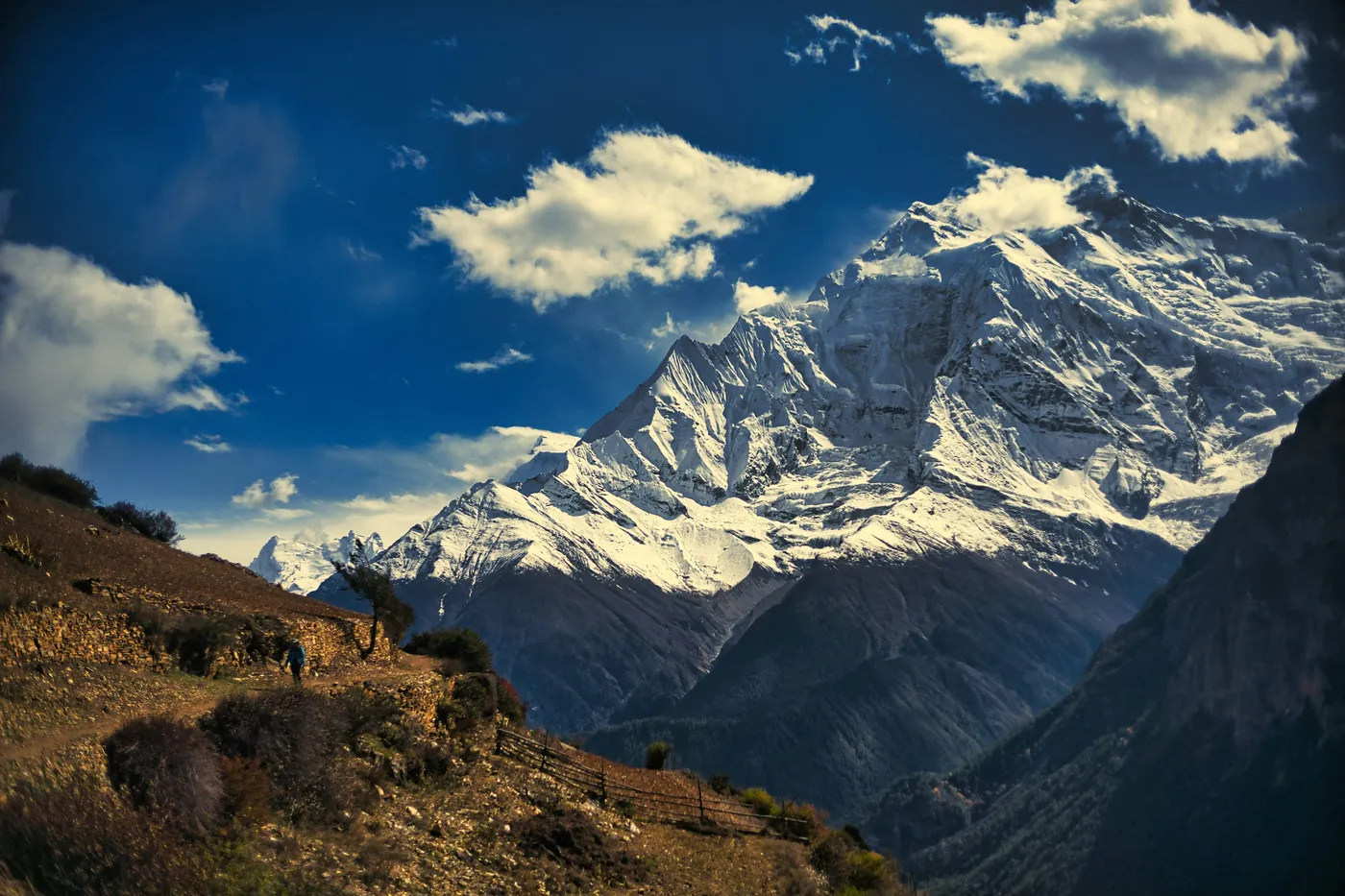 Porters carrying supplies along a mountain trail in the Annapurna region